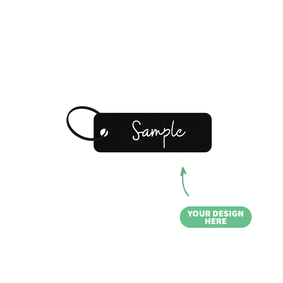 Black customizable steel keychain tag with 'Sample' text on a white background, made in Lebanon